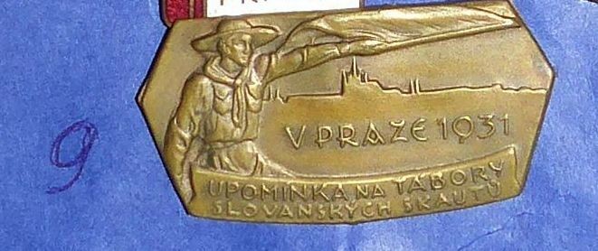 Відзнака з написом “UPOMINKA TABORY SLOVANSKYCH SKAUTU V PRAZE 1931” з рельєфним зображенням скаута. 